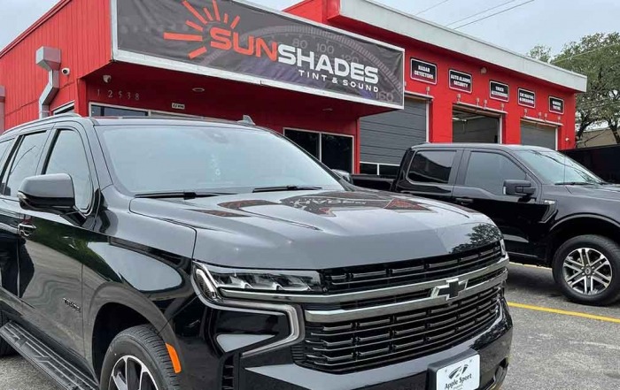Auto tint was installed on an SUV and truck parked outside of Sunshade’s Austin location.
